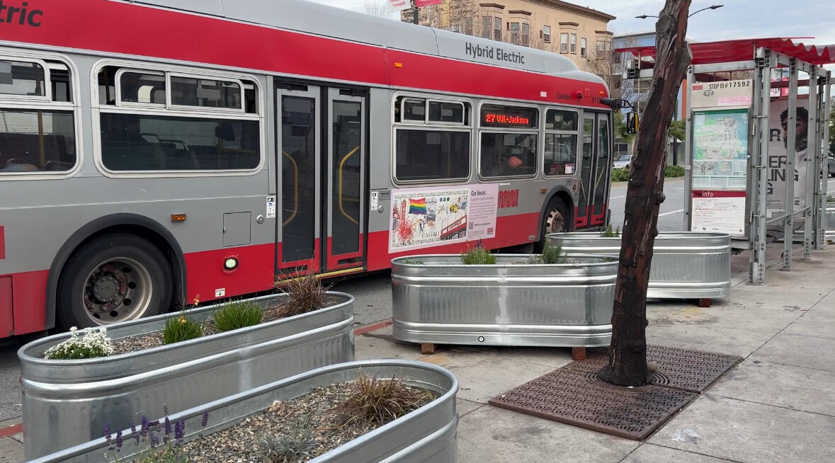 Two layers of privately installed metal tanks block access to the 27 MUNI bus.