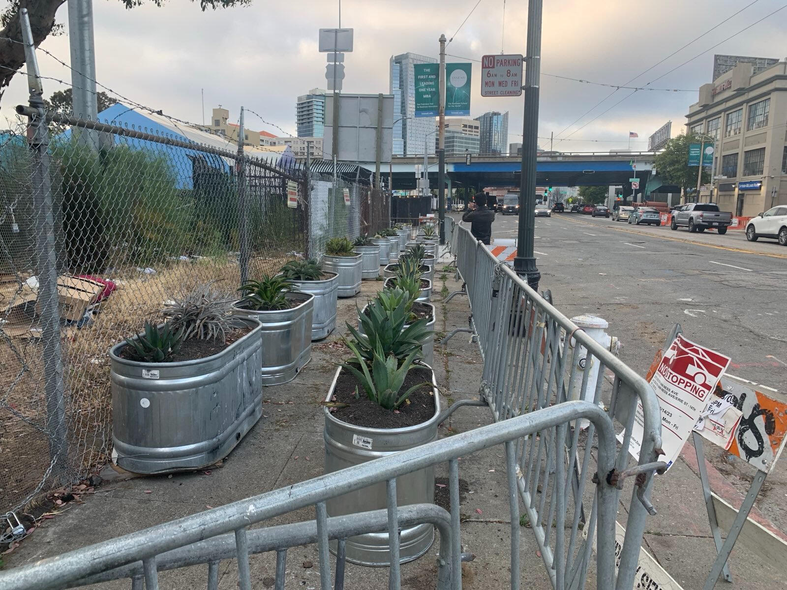 Completely barricaded sidewalk by an empty lot. This moved an encampment to a more populated, commercial area.