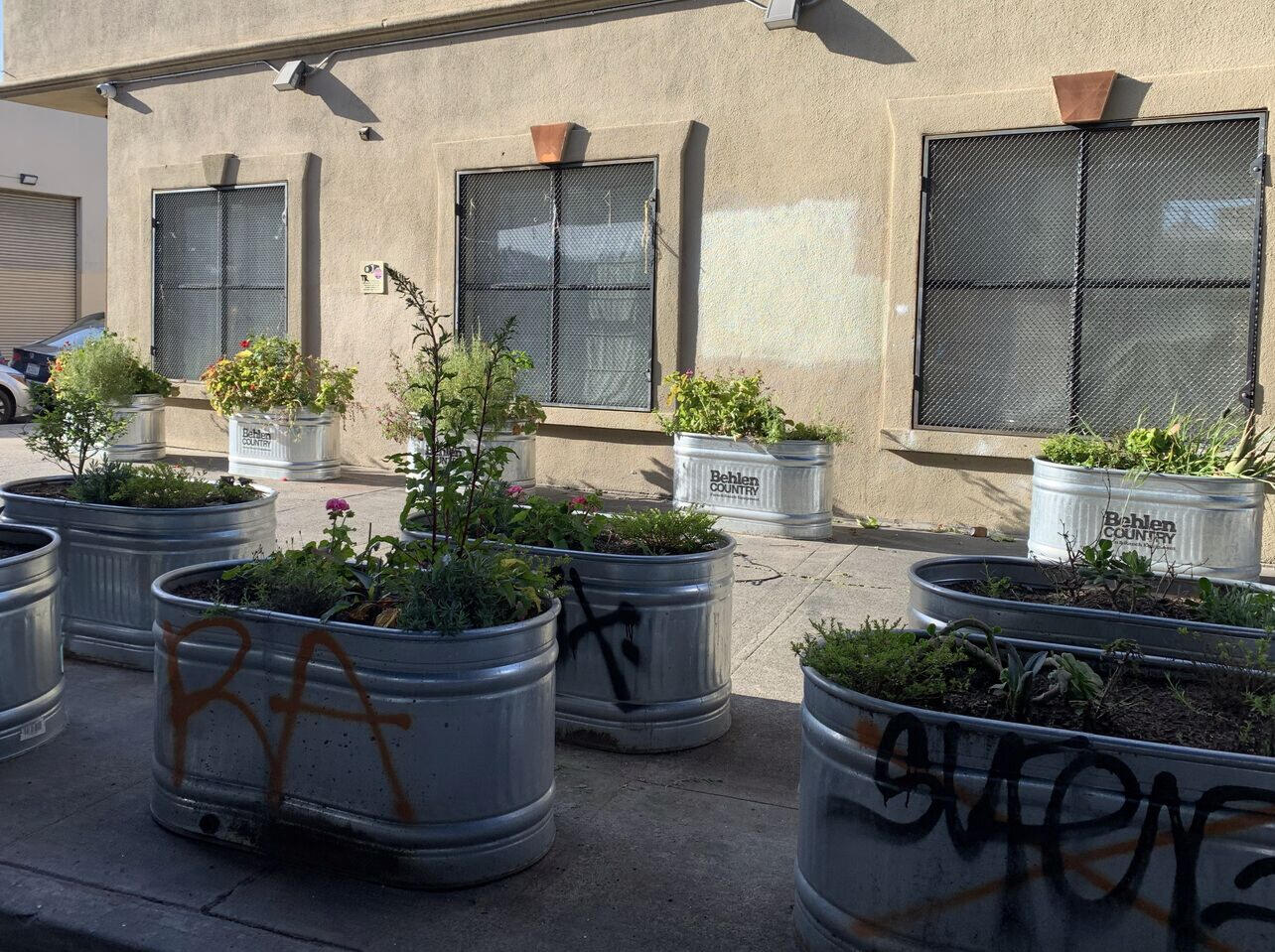 3 layers of planters block this sidewalk.